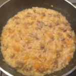 Piatto di risotto zucca e salsiccia servito in una ciotola elegante