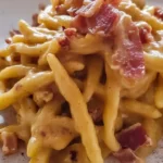 Trofie con crema di peperoni, speck e noci, piatto gustoso e colorato